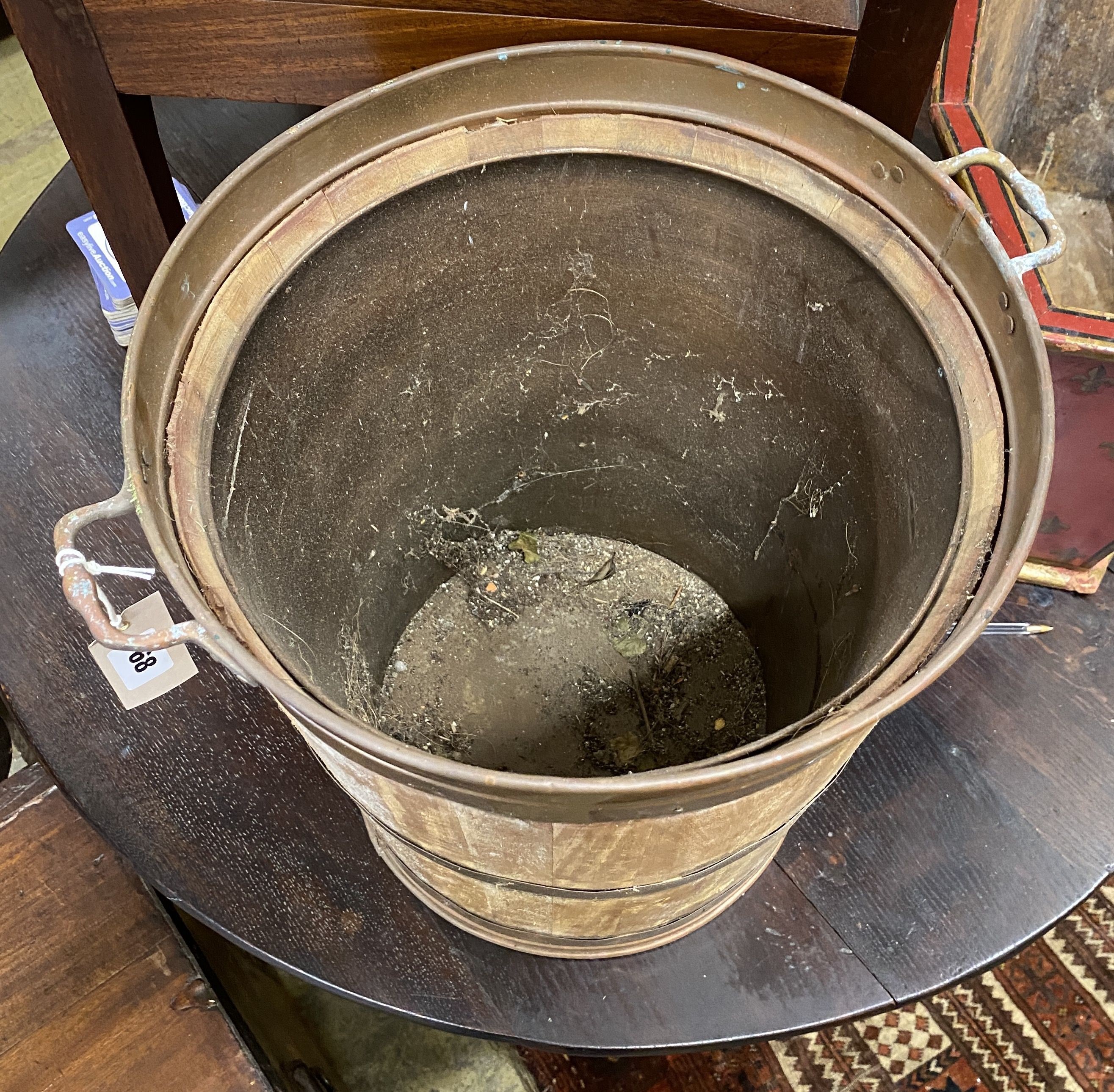 A copper bound and staved oak bucket, diameter 38cm, height 43cm